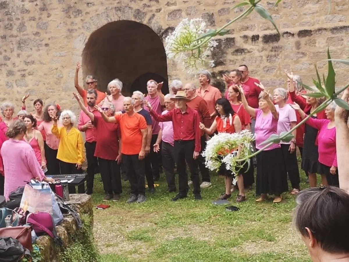 Les choristes bras levés devant les remparts